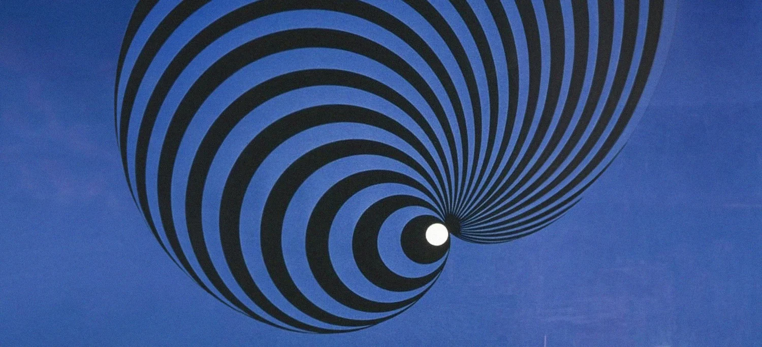 A black and blue striped spiral narrowing to a single white point.